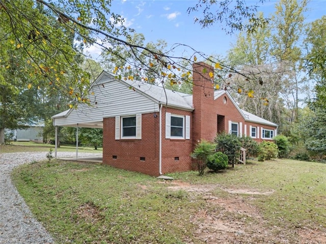 view of home's exterior featuring a yard and a carport