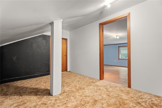 additional living space with carpet and lofted ceiling