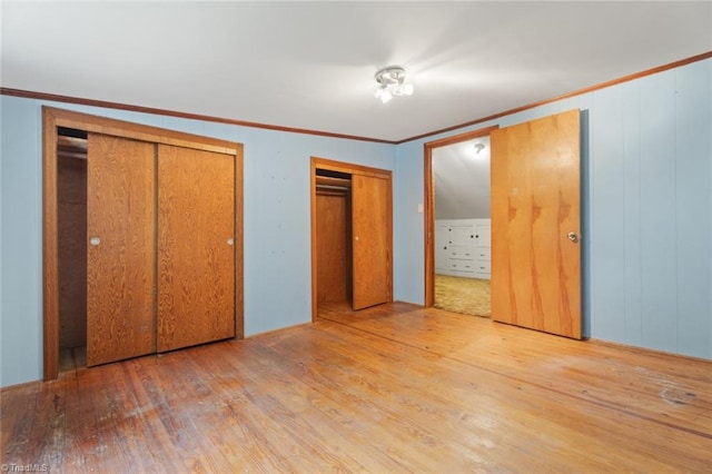 unfurnished bedroom with ornamental molding and hardwood / wood-style floors