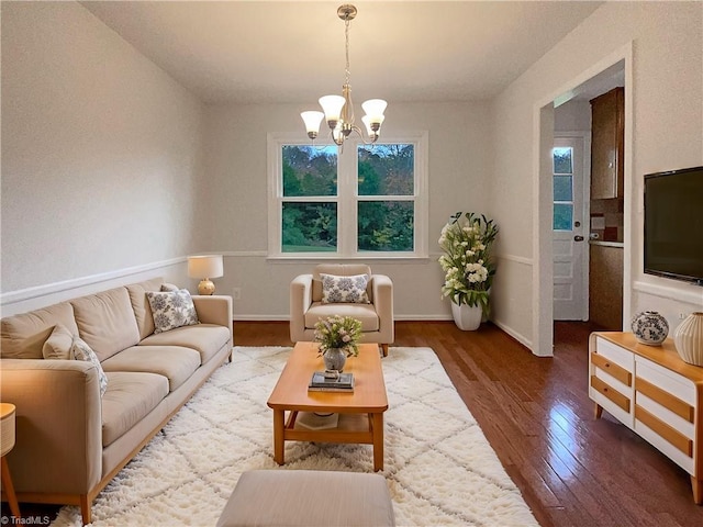 living room with hardwood / wood-style floors and an inviting chandelier