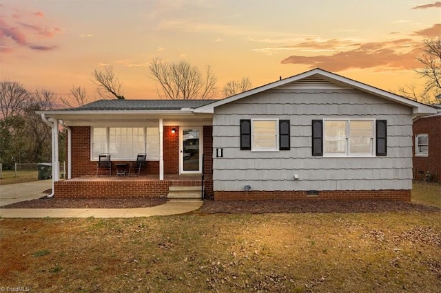 view of front of property featuring a lawn and a porch