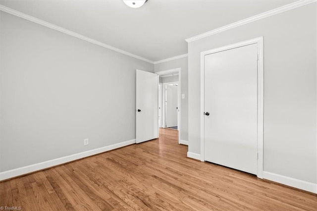 unfurnished bedroom featuring ornamental molding and light hardwood / wood-style floors