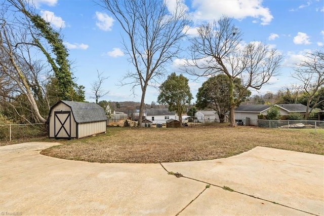 view of yard featuring a patio and a storage shed