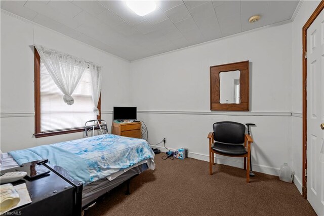 carpeted bedroom featuring crown molding