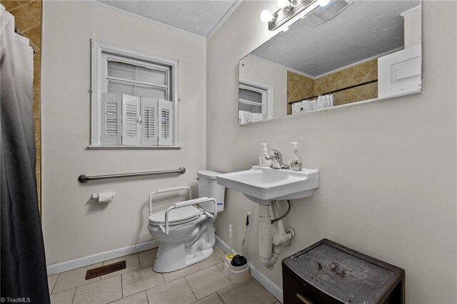 bathroom with tile patterned flooring, a shower with shower curtain, toilet, and ornamental molding