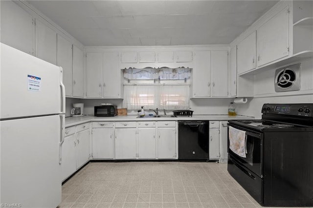 kitchen featuring black appliances, white cabinetry, and sink