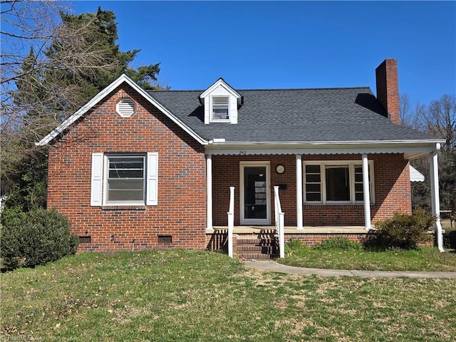 view of front of home featuring a front yard, roof with shingles, a porch, crawl space, and brick siding