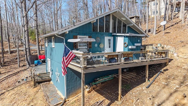 back of house featuring a wooden deck