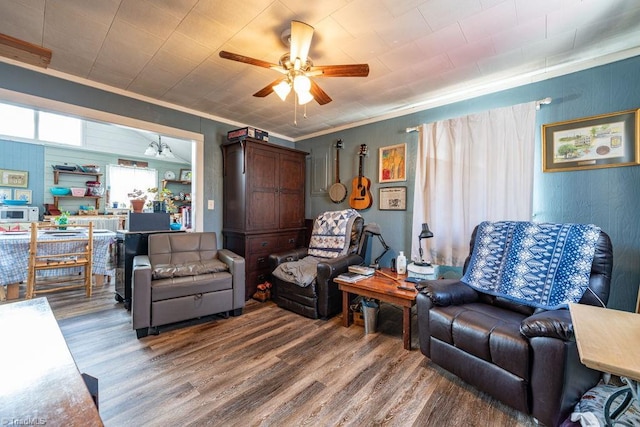 living room featuring a ceiling fan, wood finished floors, and ornamental molding