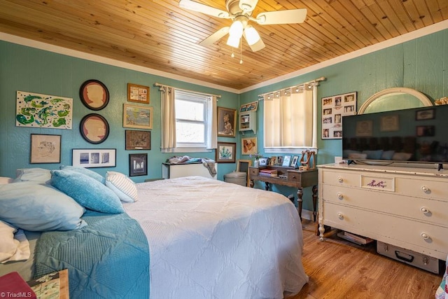 bedroom with wood ceiling, wood finished floors, a ceiling fan, and ornamental molding