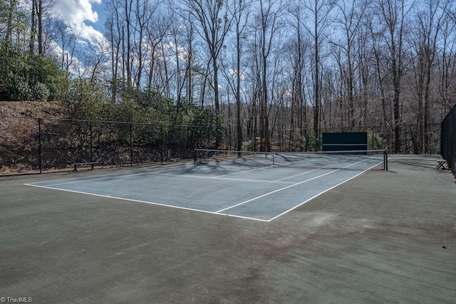 view of tennis court with fence