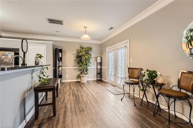 sitting room with ornamental molding, dark hardwood / wood-style flooring, and french doors