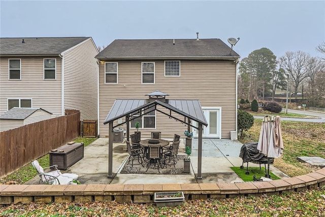 back of property featuring a gazebo, central AC unit, and a patio area