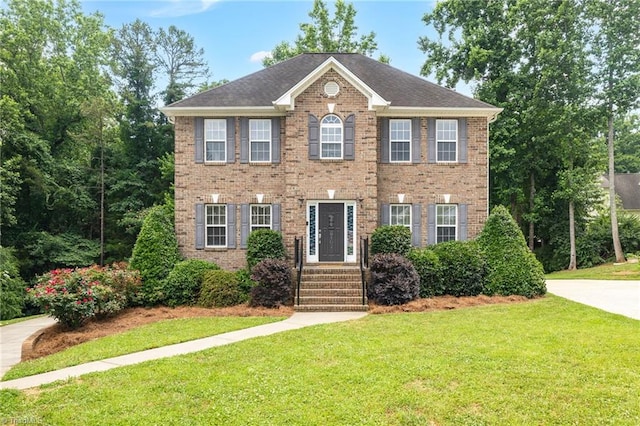6107 Hanes Way, Clemmons, NC 27012 - view of front facade featuring a front yard and brick siding