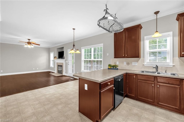 6107 Hanes Way, Clemmons, NC 27012 - kitchen featuring dishwasher, a tiled fireplace, a peninsula, decorative light fixtures, and backsplash