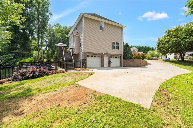6107 Hanes Way, Clemmons, NC 27012 - view of home's exterior featuring driveway, a garage, and stairs