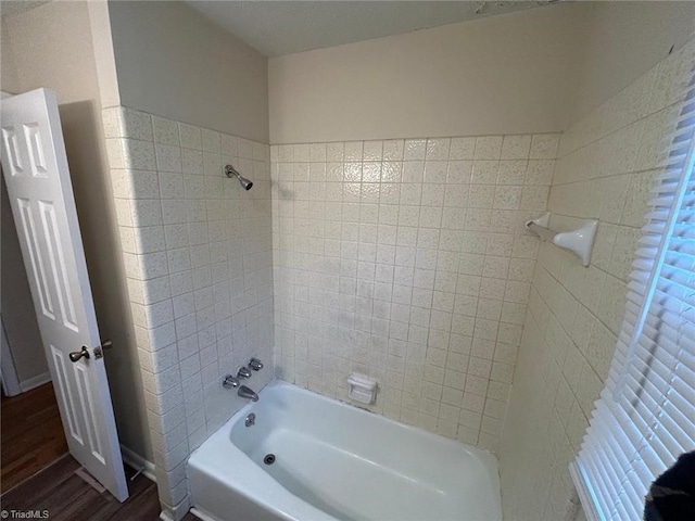 bathroom featuring tiled shower / bath combo and wood-type flooring