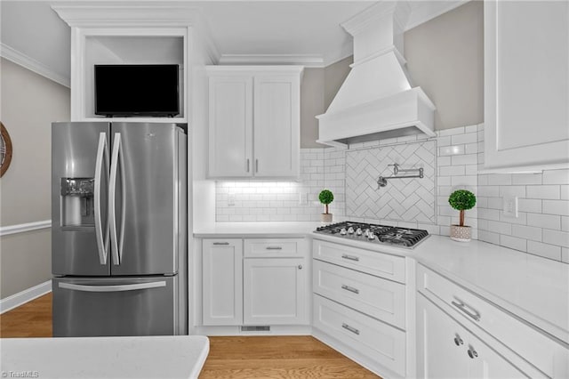 kitchen with premium range hood, light countertops, and stainless steel appliances