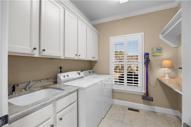 laundry area with ornamental molding, visible vents, a sink, separate washer and dryer, and cabinet space