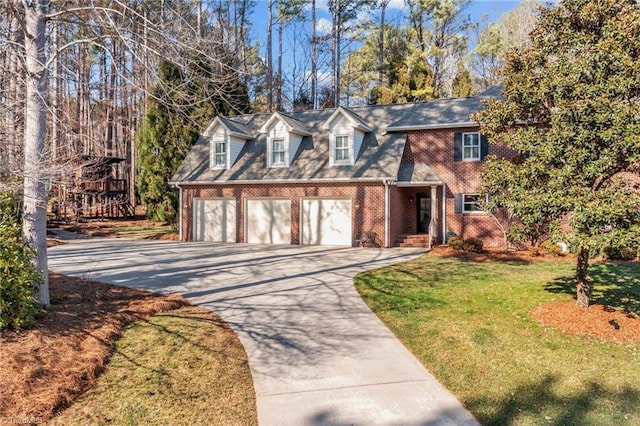 view of front of home with a front lawn, brick siding, and driveway