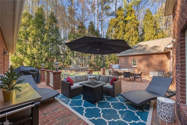 view of patio / terrace with a grill, outdoor dining space, and an outdoor living space with a fire pit