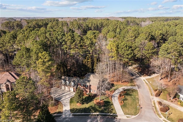 birds eye view of property featuring a view of trees