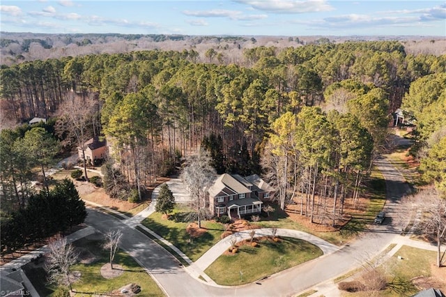 drone / aerial view featuring a forest view