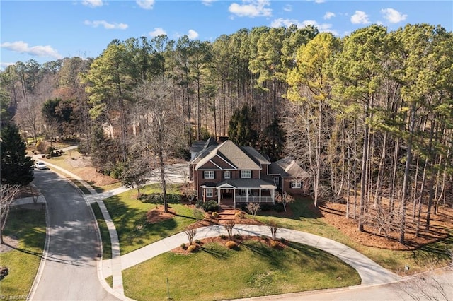 birds eye view of property with a view of trees