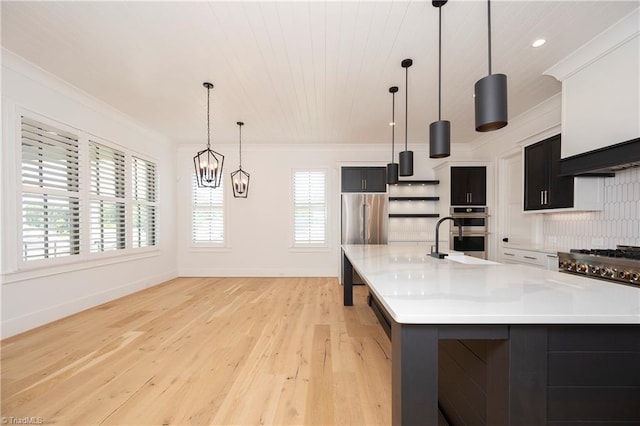 kitchen featuring crown molding, pendant lighting, light countertops, and a sink