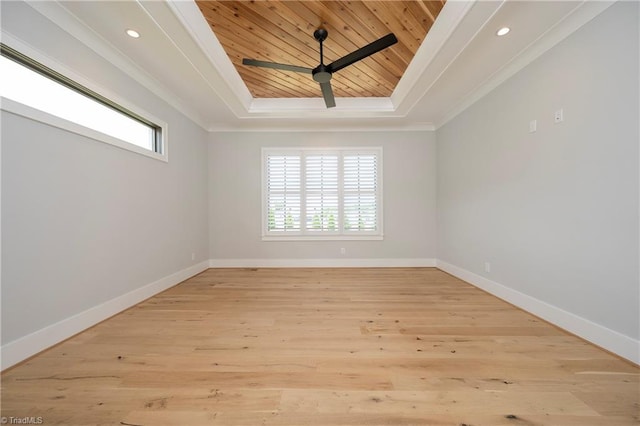 unfurnished room featuring a tray ceiling, wooden ceiling, crown molding, and baseboards