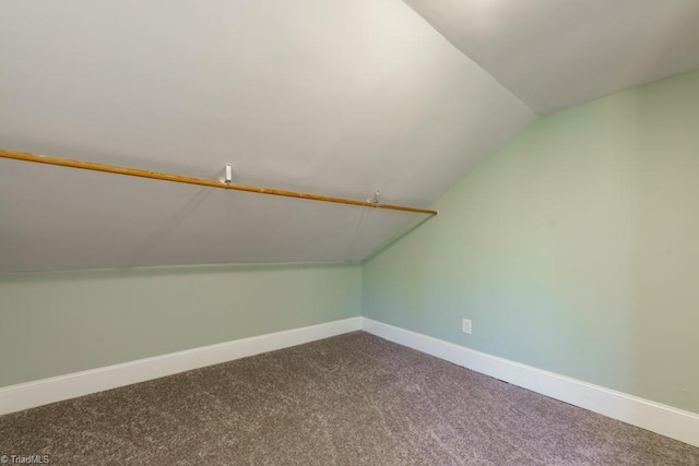 bonus room with carpet flooring and vaulted ceiling