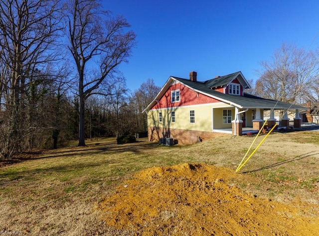 view of side of home featuring a yard