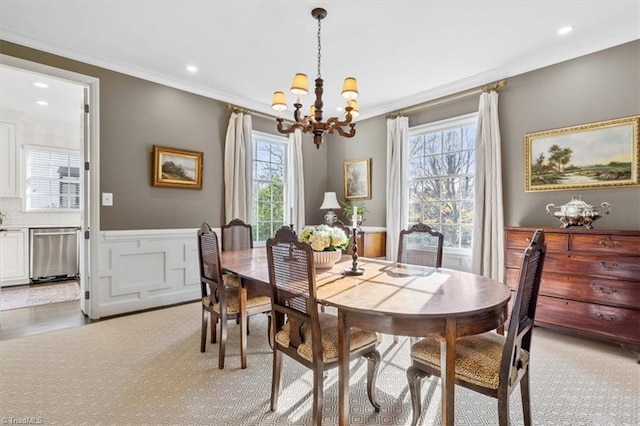 dining area featuring ornamental molding and a notable chandelier