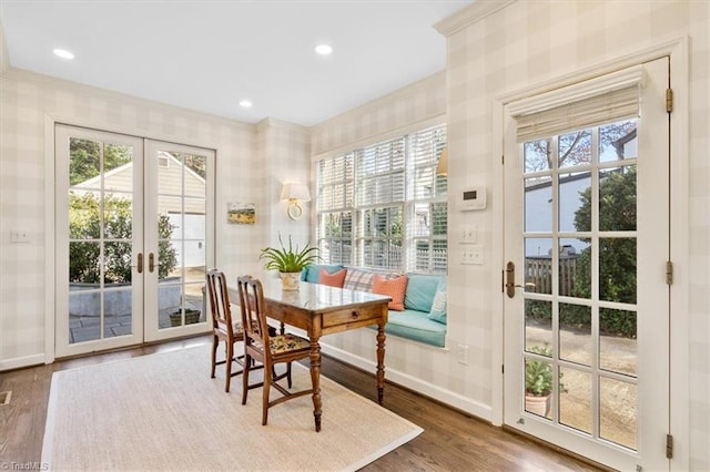 dining area with french doors, a wealth of natural light, and wood-type flooring