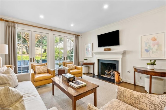 living room with crown molding, french doors, and hardwood / wood-style flooring