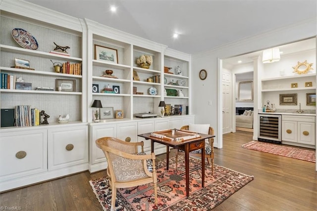 dining room featuring built in shelves, dark wood-type flooring, and wine cooler