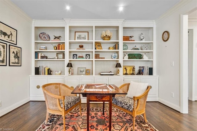 sitting room with built in features, ornamental molding, and dark wood-type flooring