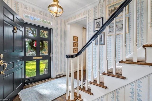 entrance foyer featuring hardwood / wood-style floors and ornamental molding