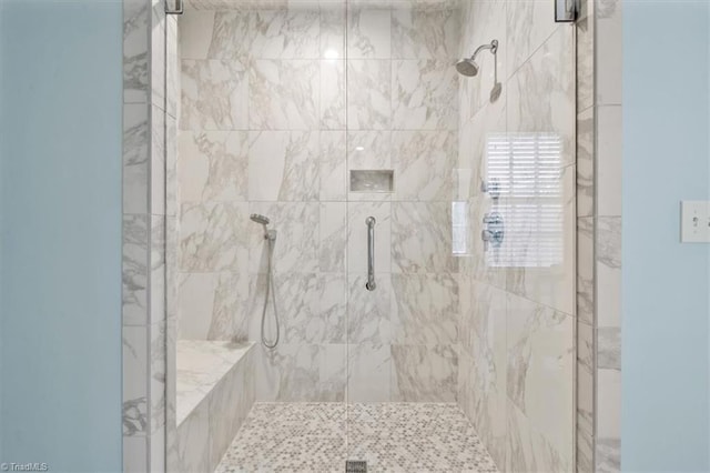 bathroom with a shower with shower door