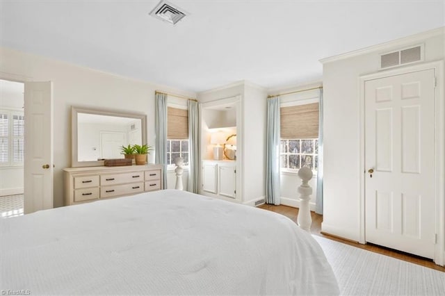 bedroom with light wood-type flooring and multiple windows