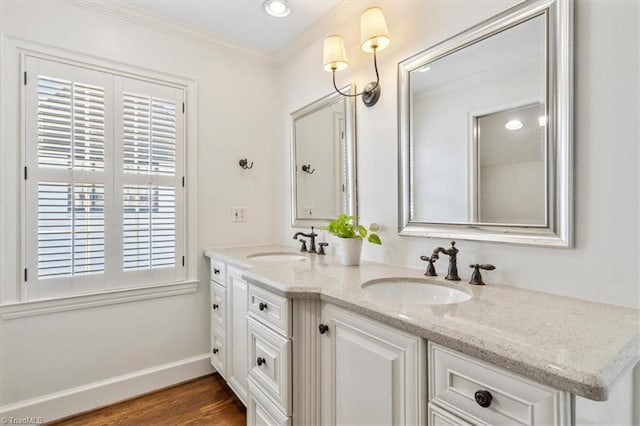 bathroom with vanity, hardwood / wood-style flooring, and ornamental molding