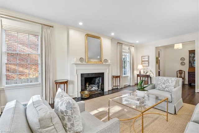 living room with a wealth of natural light, hardwood / wood-style floors, and crown molding