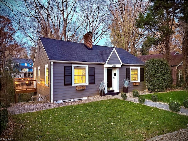 ranch-style house with a wooden deck and a front lawn