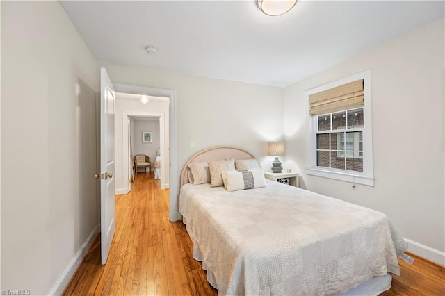 bedroom with hardwood / wood-style floors