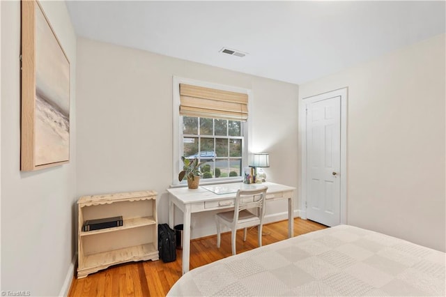 bedroom with hardwood / wood-style floors