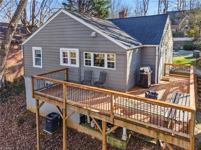 back of house with central AC unit and a wooden deck