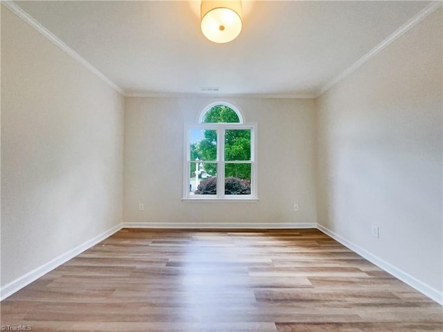 unfurnished room with light wood-type flooring and crown molding