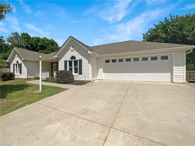 single story home featuring a garage and a front yard