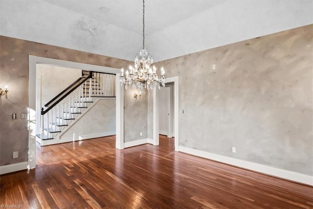 unfurnished dining area featuring dark wood-type flooring and an inviting chandelier