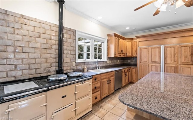 kitchen featuring light stone countertops, light tile patterned floors, sink, stainless steel dishwasher, and backsplash